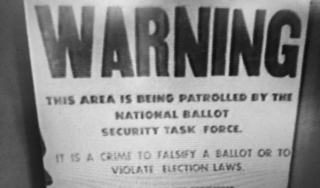 Historical voter suppression sign that reads "WARNING THIS AREA IS BEING PATROLLED BY THE NATIONAL BALLOT SECURITY TASK FORCE. IT IS A CRIME TO FALSIFY A BALLOT OR TO VIOLATE ELECTION LAWS."