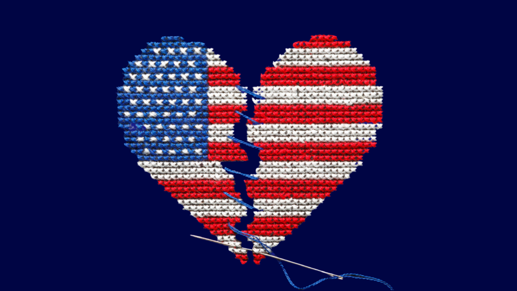 A once broken heart-shaped American flag that is being sewed back together with a needle and thread