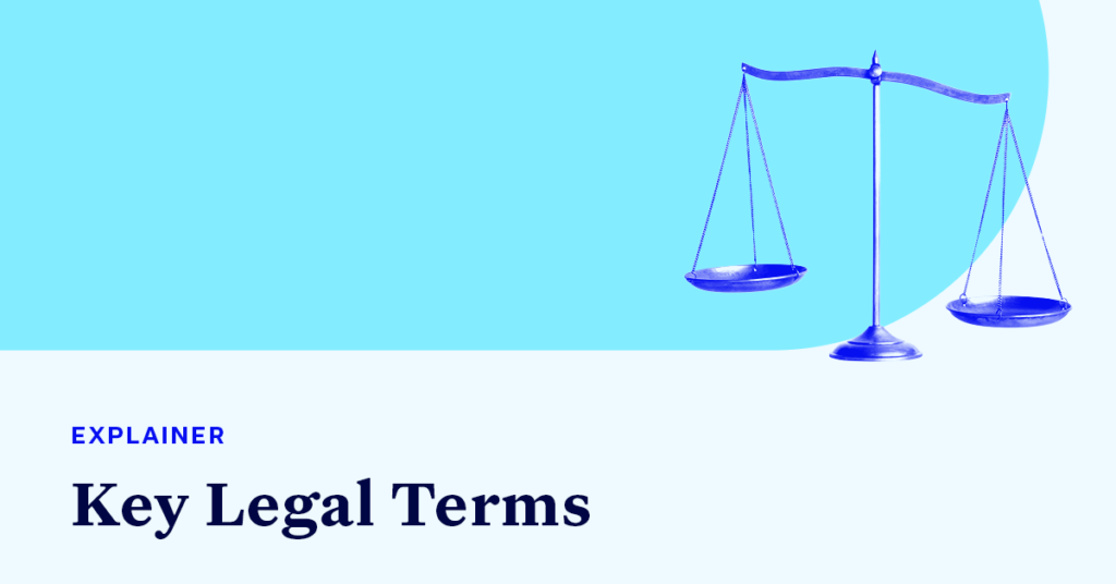 A scale accompanied by small text that says "EXPLAINER" and large text that says “Key Legal terms"