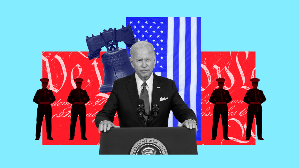 Light blue background with President Joe Biden standing at a podium with sillouettes of soldiers standing behind him in front of a red-toned background and "We the People" written on it in white, a blue-toned liberty bell and blue-toned American flag behind Biden.