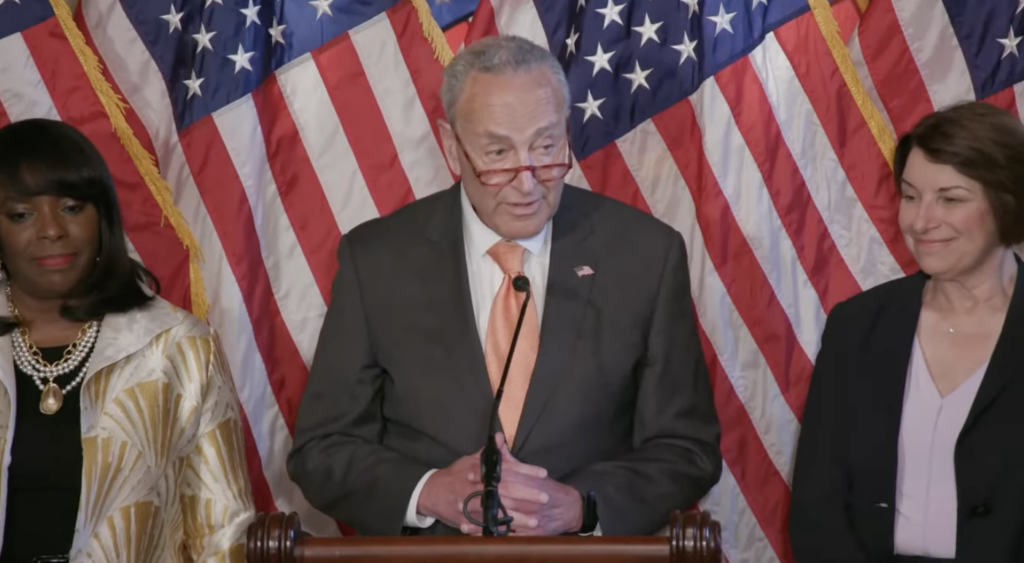 Senate Majority Leader Chuck Schumer, Sen. Amy Klobuchar and Rep. Terri Sewell stand at a press conference reintroducing the Freedom to Vote Act.