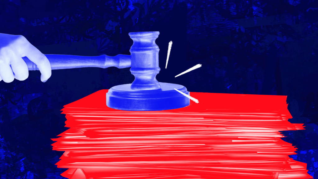 A blue-toned gavel slams on a stack of red documents against a dark blue background.
