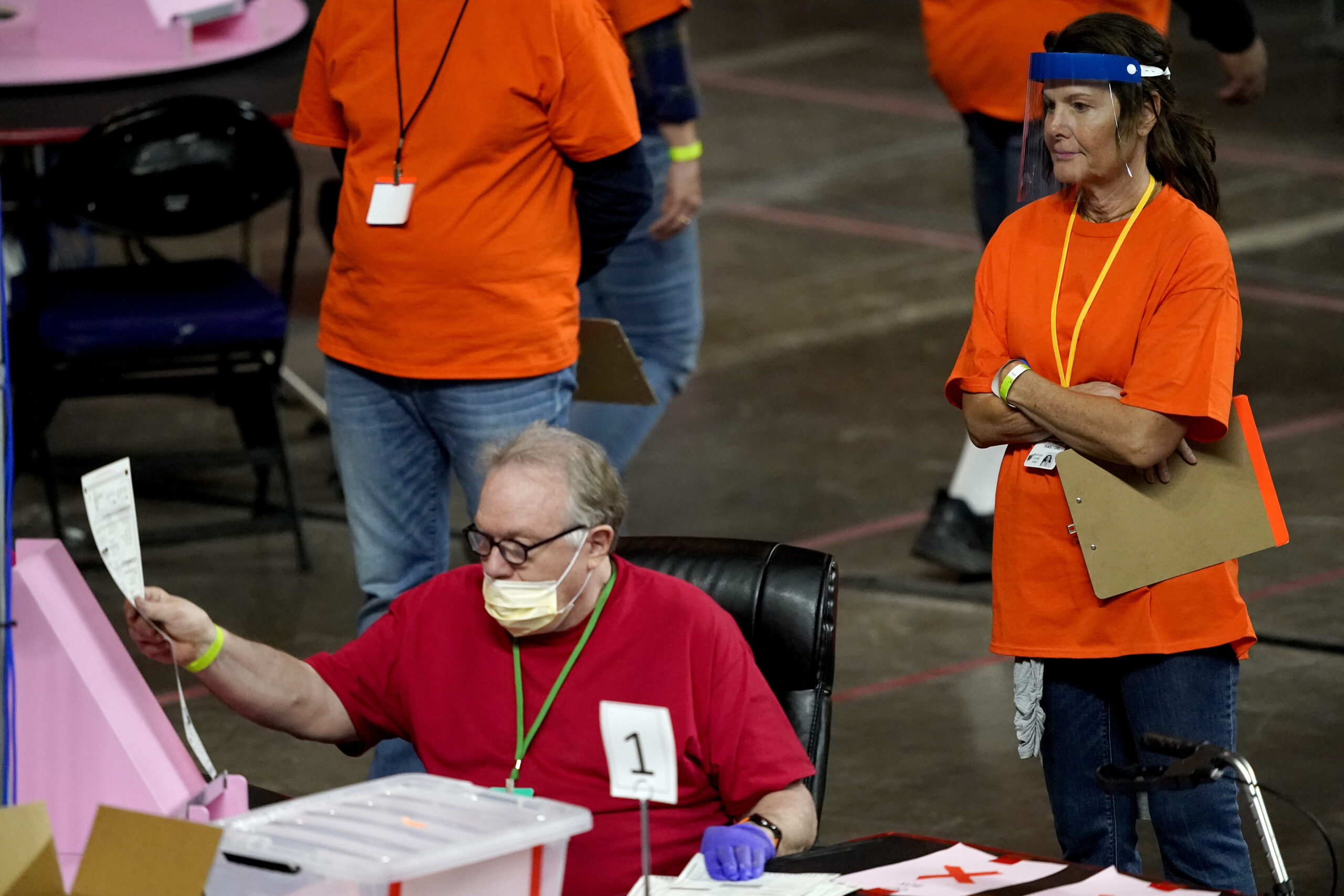 A photo of workers hand counting ballots in Arizona