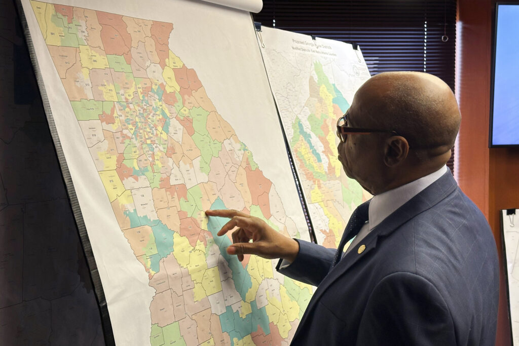 A man reviews proposed Georgia maps.