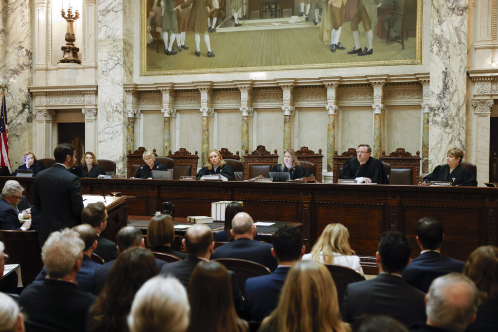 The Wisconsin Supreme Court listens to arguments from Wisconsin Assistant Attorney General Anthony D. Russomanno, representing Gov. Tony Evers, during a redistricting hearing at the state Capitol, Nov. 21, 2023, in Madison, Wis. (Ruthie Hauge/The Capital Times via AP, Pool, File)