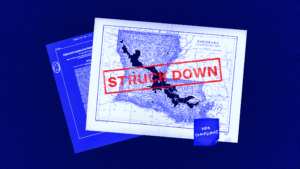 Image shows Louisiana's current congressional map that was struck down by a federal district court. The words "STRUCK DOWN" are written on top of the map in red letters. A sticky note that says VRA compliant is attached to the bottom of the map.