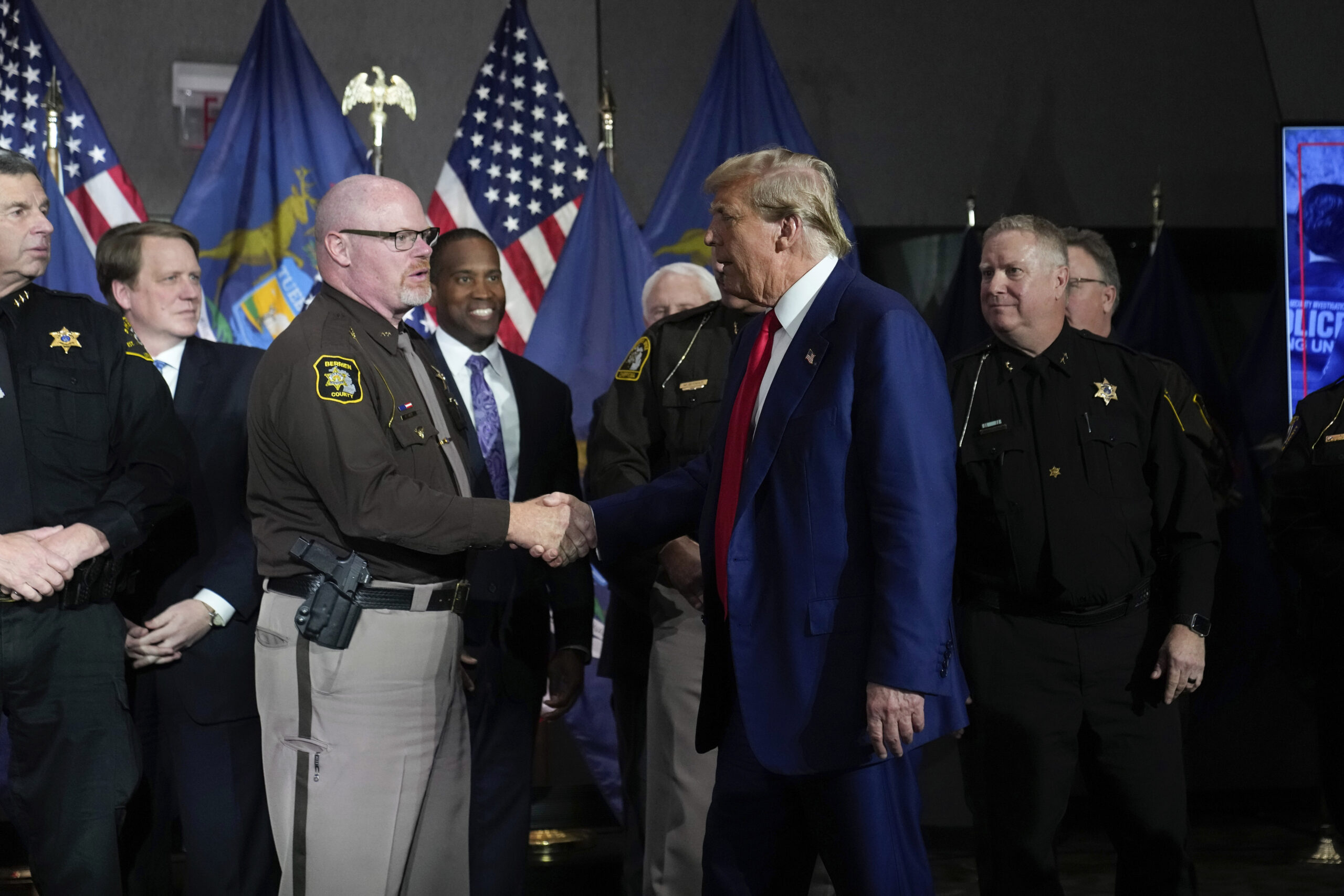 Republican presidential candidate former President Donald Trump greets law enforcement officers at a campaign event in Grand Rapids, Mich., Tuesday, April 2, 2024. (AP Photo/Paul Sancya)
