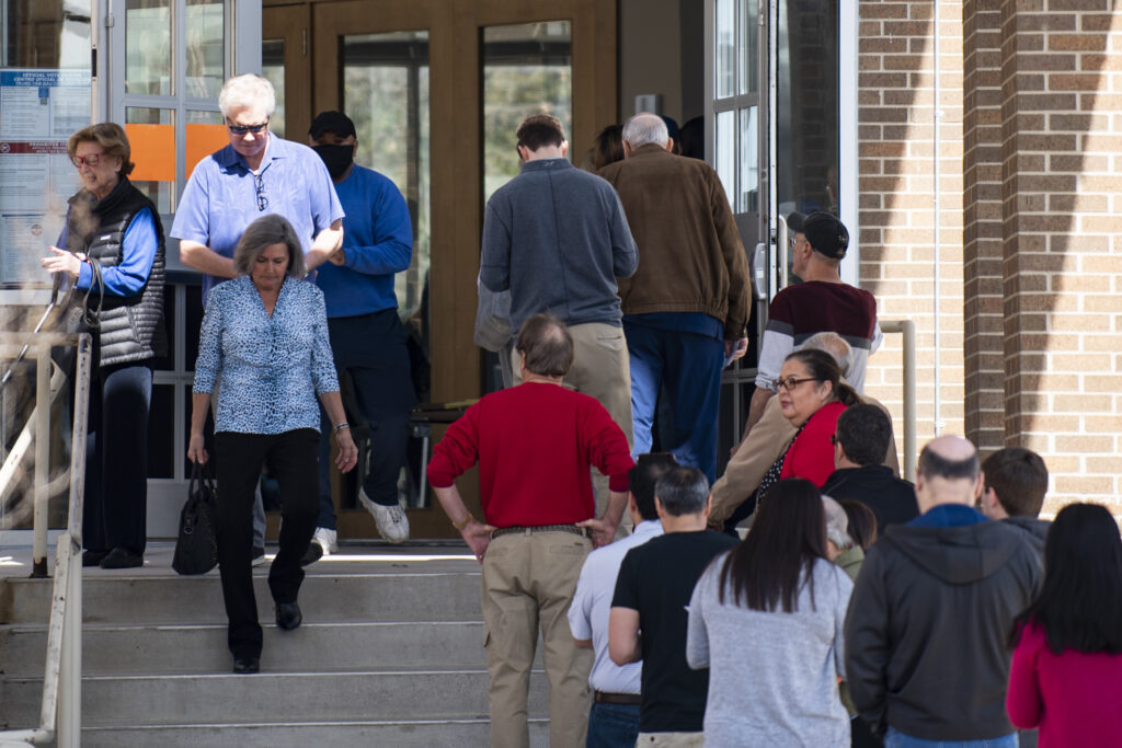 Voters enter and exit a polling location.