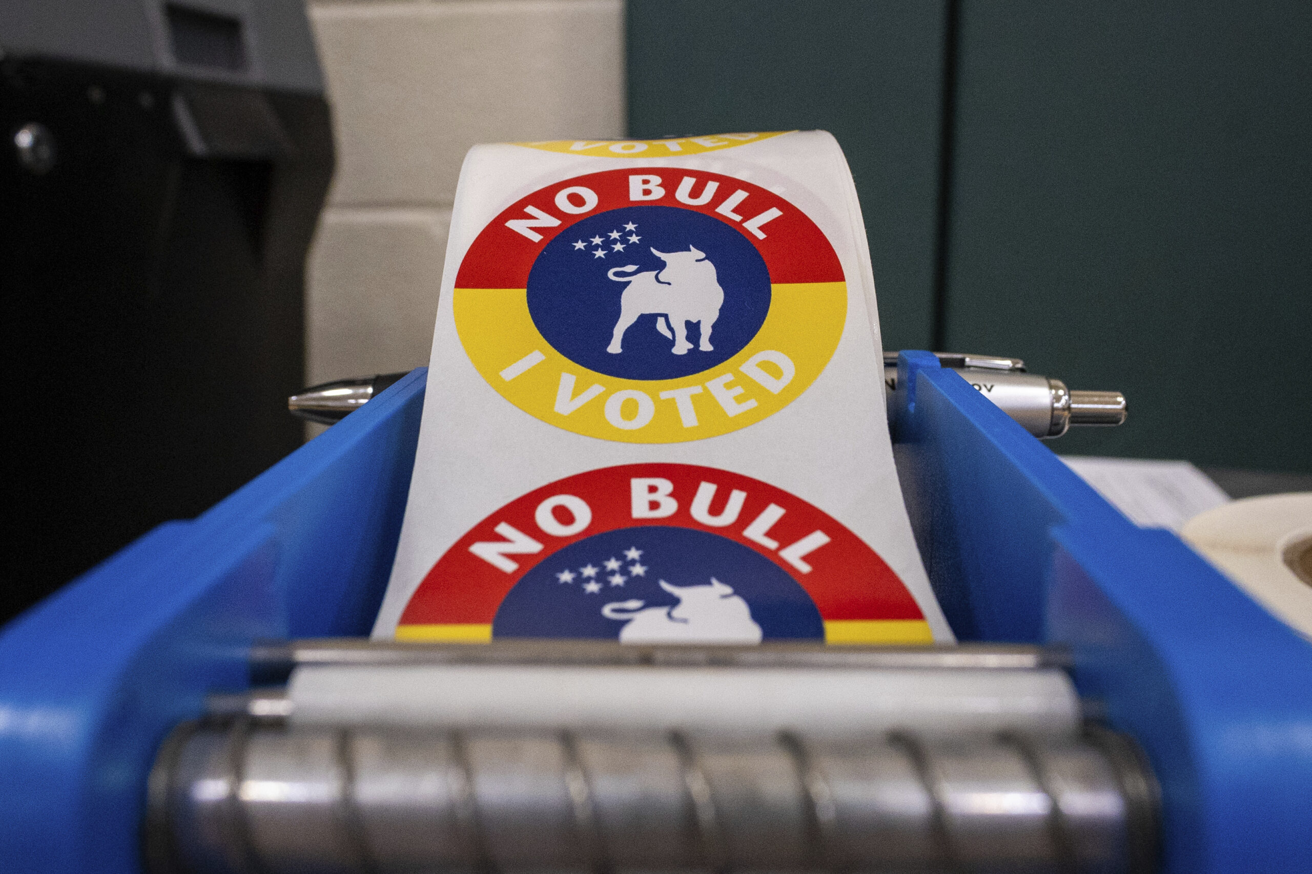 A roll of "No Bull I Voted" stickers sit inside a polling station at W. J. Brogden Middle School in Durham, N.C. on Nov. 5, 2024. These "I Voted" stickers are unique to Durham and were designed in 2020. (Photo by Joseph A. Navin/Sipa USA)(Sipa via AP Images)