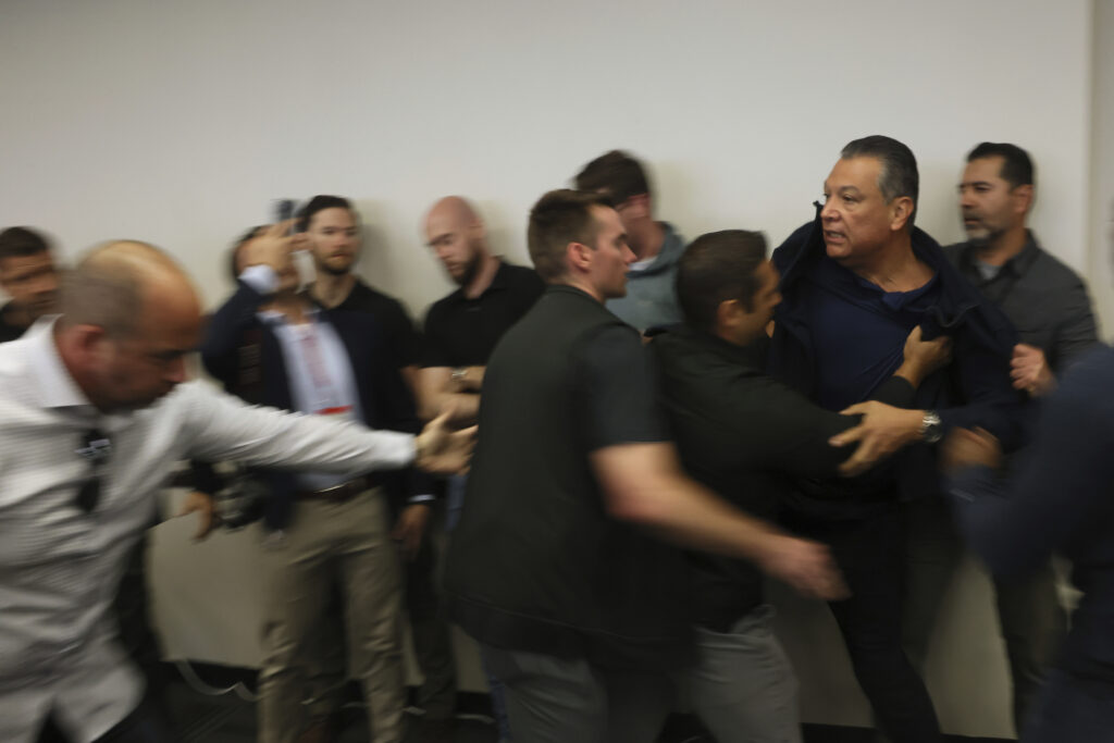 Sen. Alex Padilla being forcibly removed from a press conference Thursday by plain-clothes federal agents.