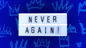 "Never Again" against blue background with crowns