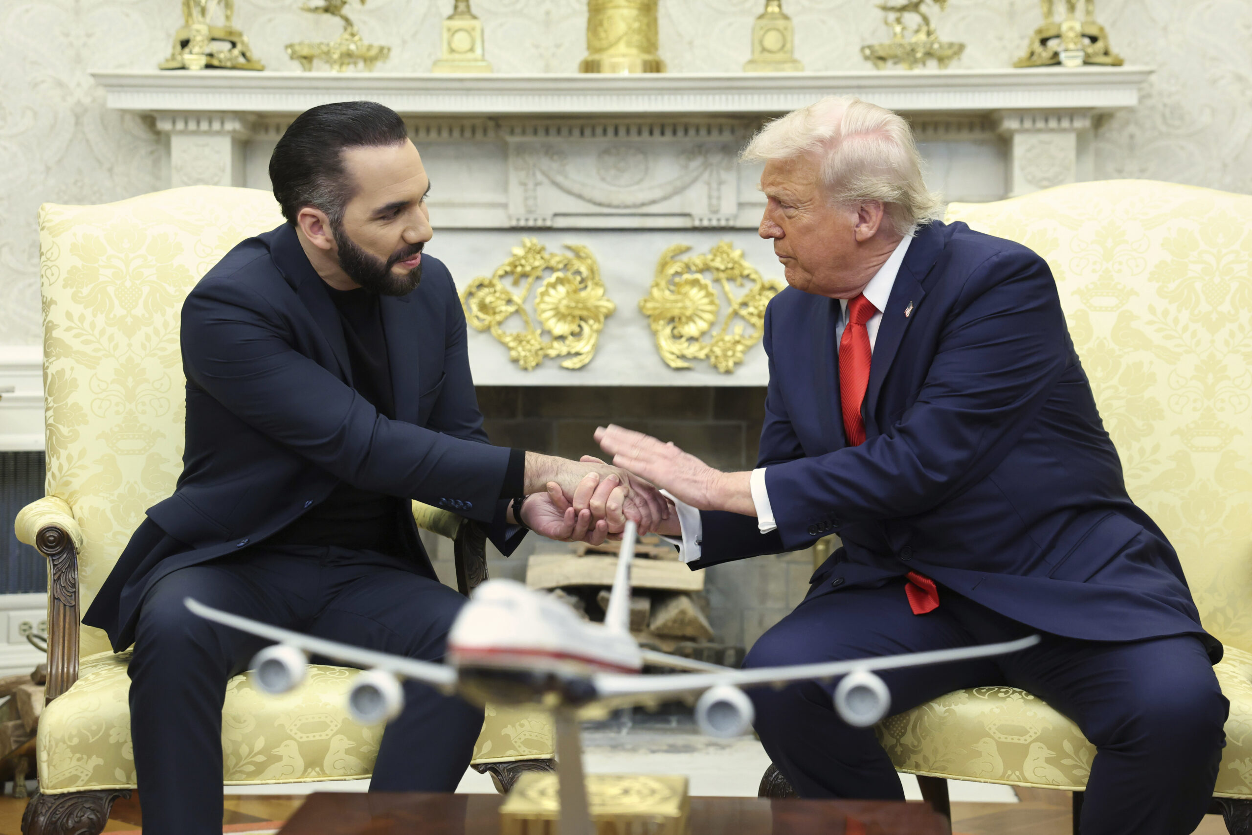 President Trump shaking hands with El Salvador's President Nayib Bukele during an oval office meeting.