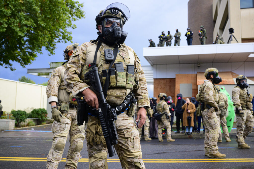Federal law enforcement agents outside of an Immigration and Customs Enforcement building in Portland, Oregon, in October 2025. 