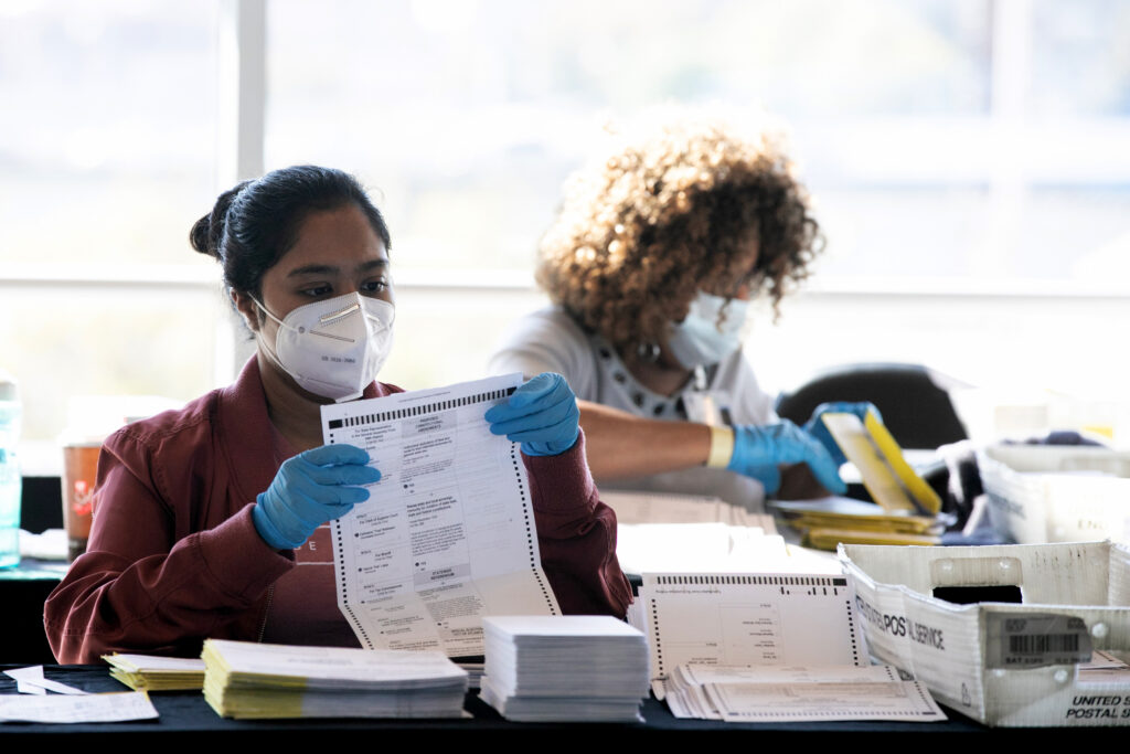 Election workers count Fulton County ballots at State Farm Arena on November 4, 2020 in Atlanta, Georgia.