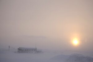 The afternoon sun hangs low as it shines through the snow at the airport in Nome, Alaska, on Feb. 13, 2019. (AP Photo/Wong Maye-E)