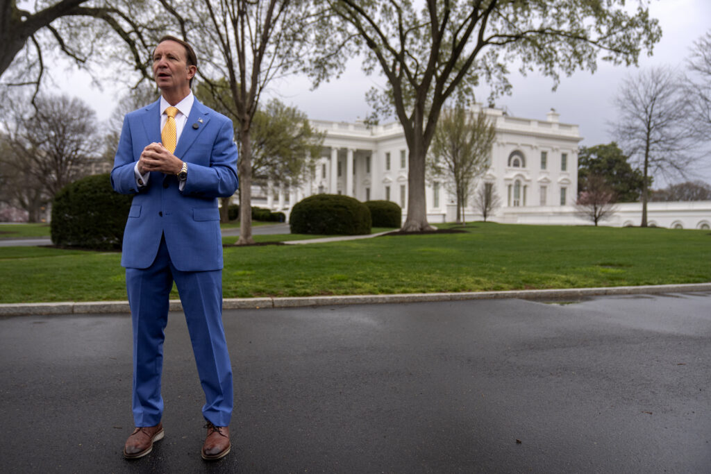 Louisiana Gov. Jeff Landry records a social media video outside the White House, Monday, March 24, 2025, in Washington. (AP Photo/Mark Schiefelbein)