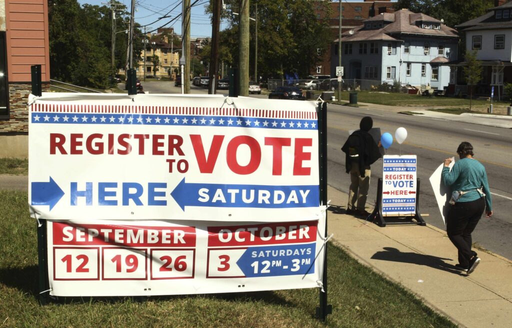 Locals holds a signs to help people to register to vote in September 2020 in Cincinnati, Ohio. (Photo: Ernest Coleman/ZUMA Wire/Cal Sport Media via AP Images)