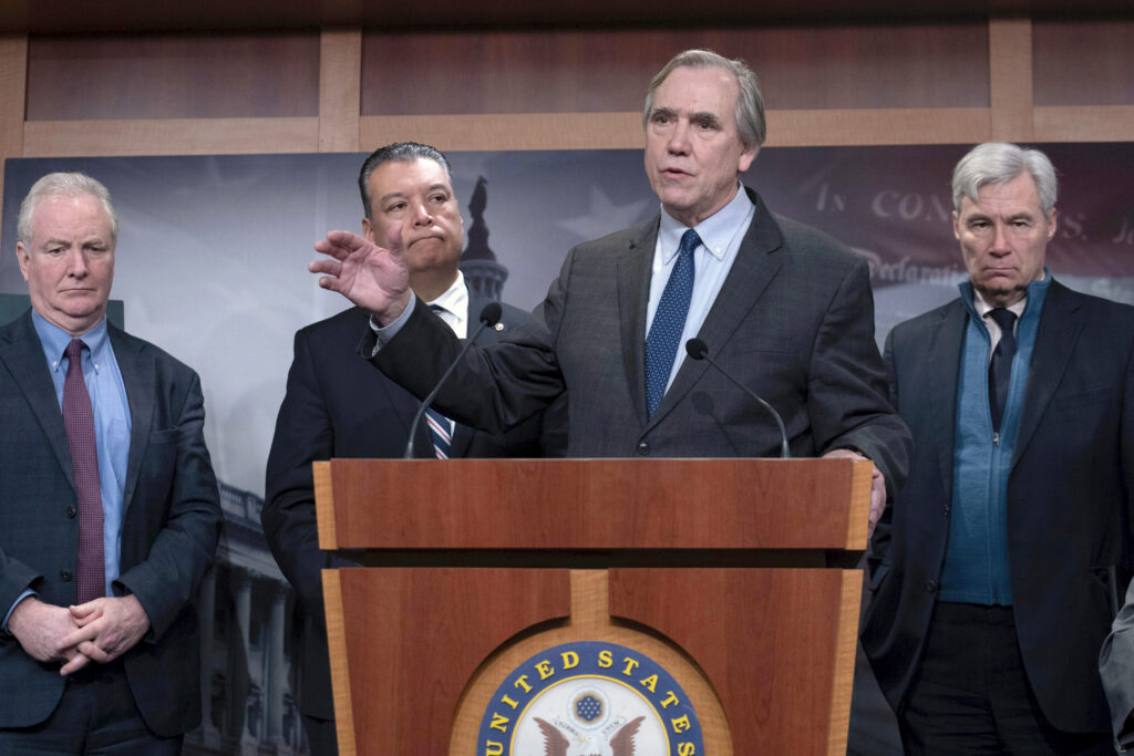 Sen. Jeff Merkley, D-Ore., flanked by from left, Sen. Chris Van Hollen, D-Md., Sen. Alex Padilla, D-Calif., and Sen. Sheldon Whitehouse, D-R.I., speaks during a news conference at the Capitol in Washington, Thursday, Jan. 30, 2025. (AP Photo/Jose Luis Magana)
