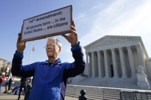 A person holding a sign outside the U.S. Supreme Court in April 2026 in Washington, D.C. (Photo: Al Drago/Getty Images)
