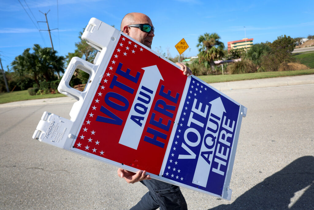 An election official setting up a voting sign in Fort Myers, Florida, in October 2022. (Photo: Joe Raedle/Getty Images)