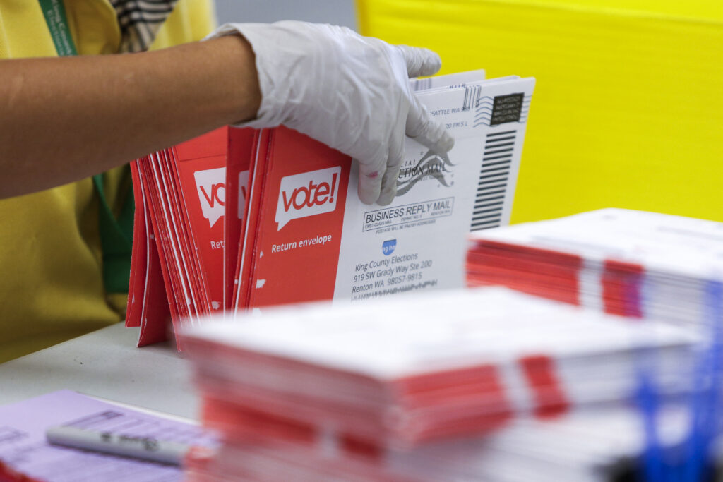 An election worker opening envelopes containing mail ballots in Renton, Washington in August 2020. (Photo: Jason Redmond/AFP via Getty Images)