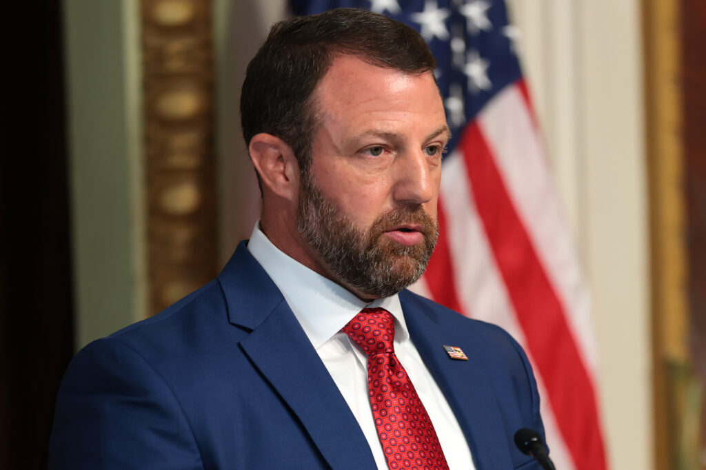 U.S. Secretary of Homeland Security Markwayne Mullin speaking in the Eisenhower Executive Office Building in July 2026 in Washington, D.C. (Photo: Anna Moneymaker/Getty Images)