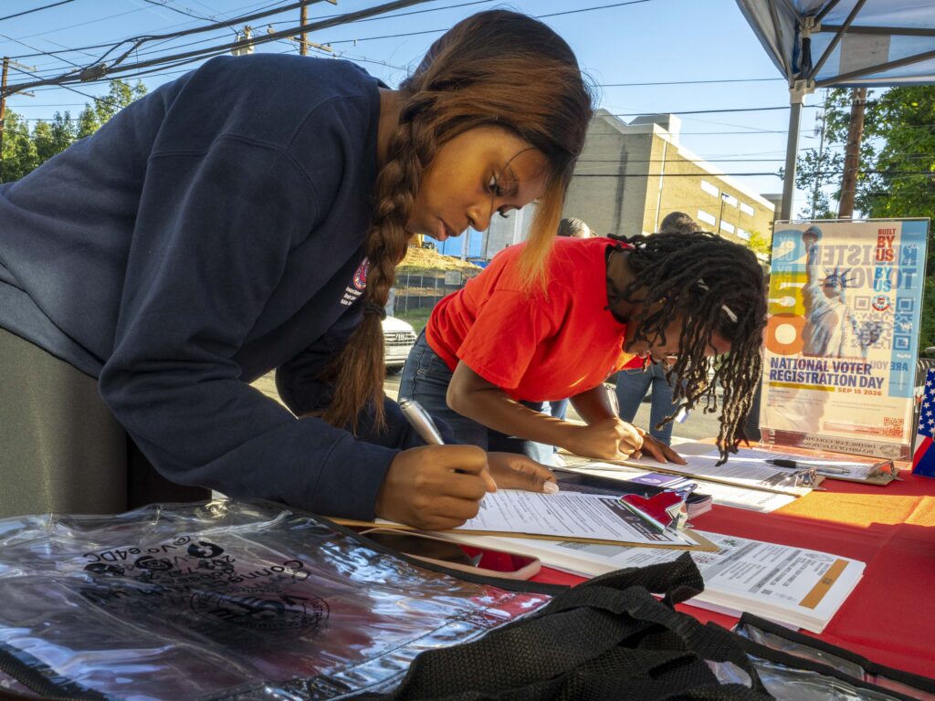 On National Voter Registration Day, Howard University students fill out forms to volunteer to be a poll worker.
