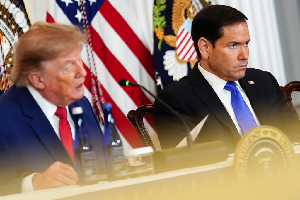 Secretary of State Marco Rubio listens as President Donald Trump speaks during a roundtable on the American mining industry, Friday, Aug. 7, 2026, at the State Department in Washington. (AP Photo/Julia Demaree Nikhinson)