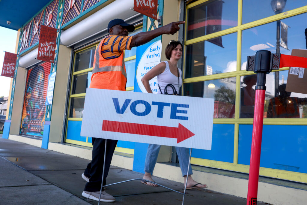 A poll worker directs a voter to a polling station in October 2024 in Miami, Florida. (Photo: Joe Raedle/Getty Images)