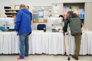 Voters pick up their ballots on the first day of early voting in Minnesota at the Elections & Voter Services building, Friday, Sept. 18, 2026, in Minneapolis. (AP Photo/Ellen Schmidt)