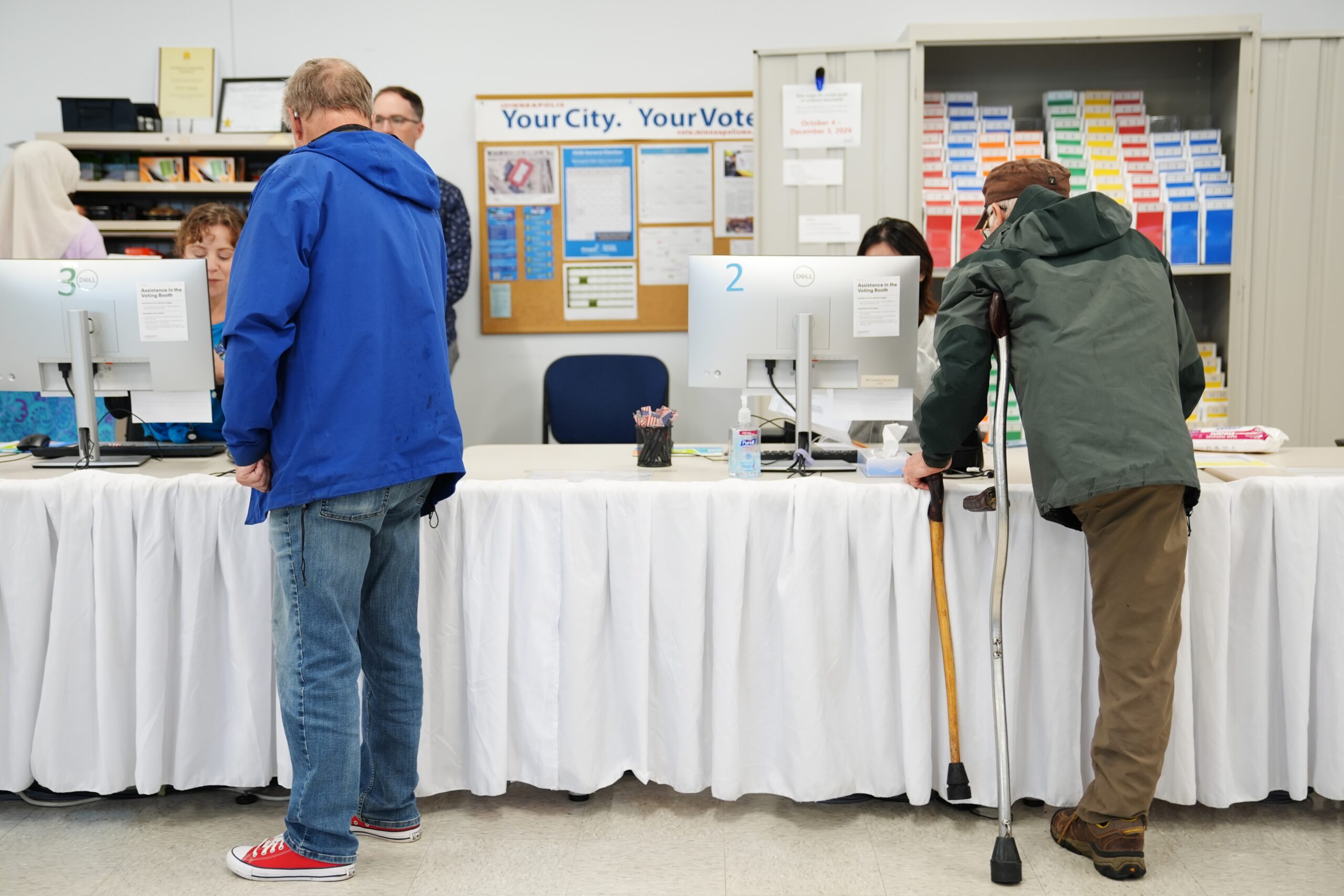 Voters pick up their ballots on the first day of early voting in Minnesota at the Elections & Voter Services building, Friday, Sept. 18, 2026, in Minneapolis. (AP Photo/Ellen Schmidt)