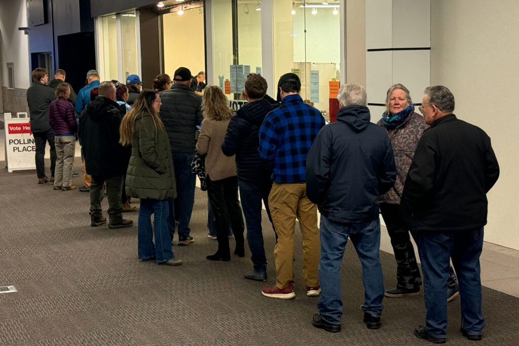 Voters stand in line at an early voting location in a mall in Anchorage, Alaska, on Wednesday, Oct. 21, 2026. (AP Photo/Haven Daley)