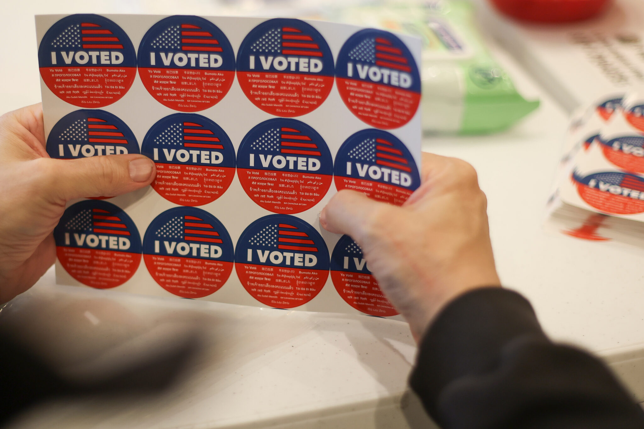 An election worker prepares ''I Voted'' stickers at a vote center in the Pacific Palisades neighborhood of Los Angeles, California, on October 25, 2026