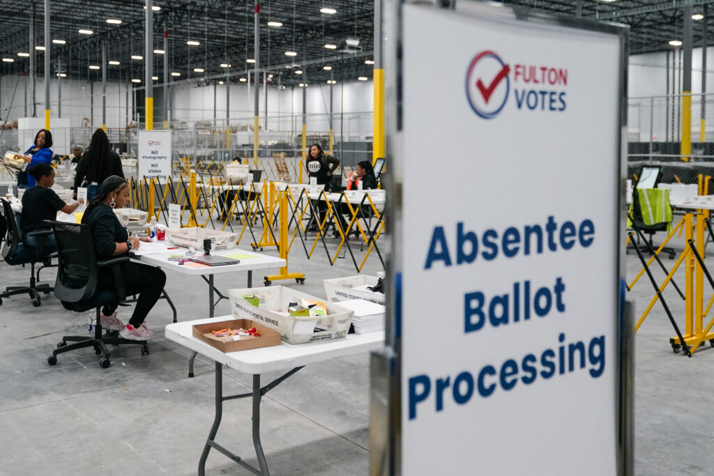 Fulton County elections workers process absentee ballots at Fulton County Elections Hub and Operations Center on November 4, 2024. (Photo by ELIJAH NOUVELAGE/AFP via Getty Images)