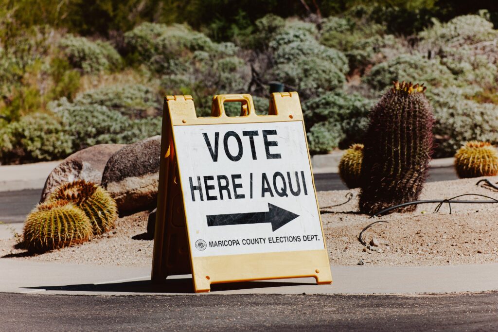 A sign points to a voting center on October 7, 2026. (Photo by Olivier Touron / AFP via Getty Images)