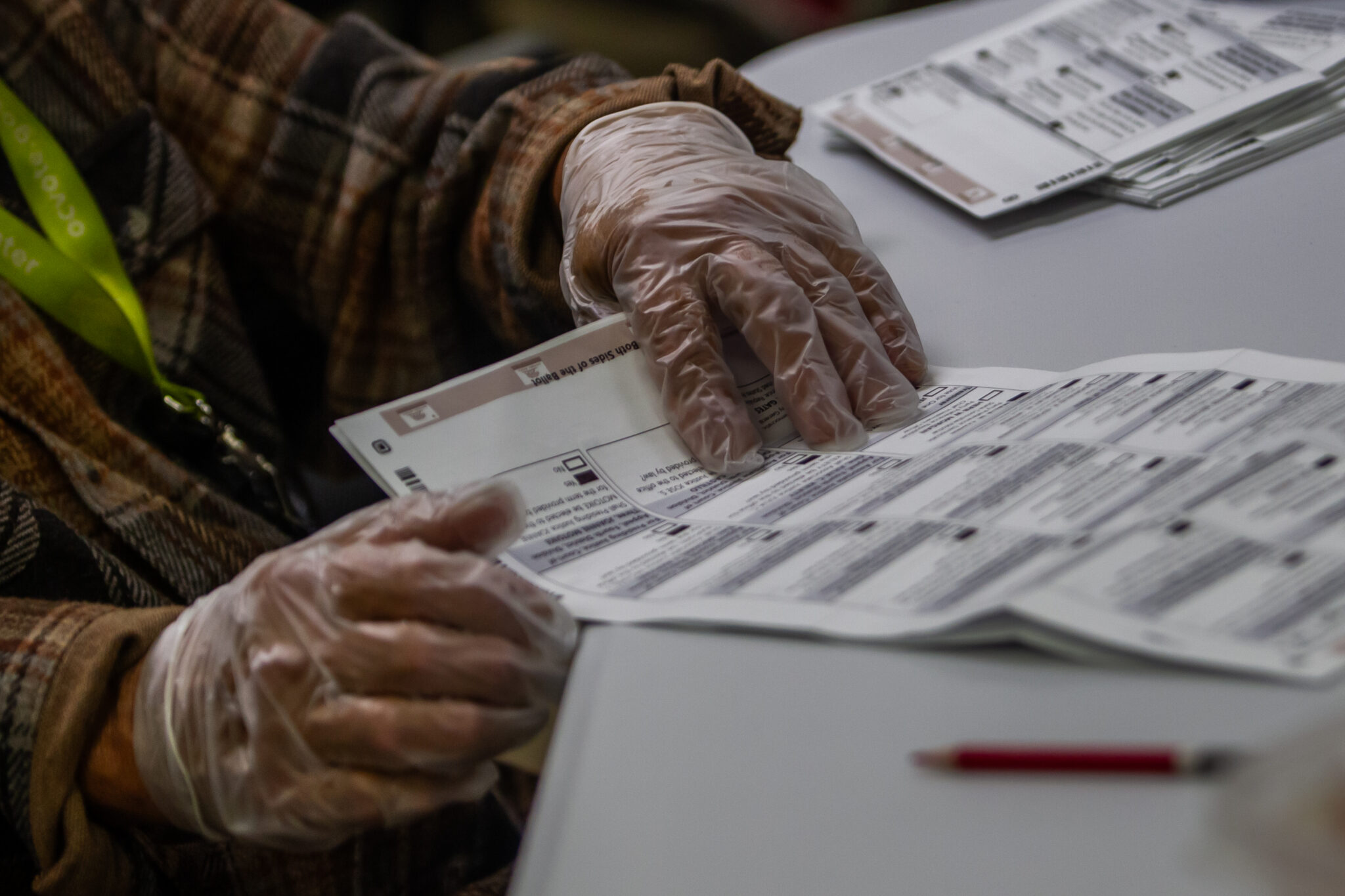 SANTA ANA, CALIFORNIA - OCTOBER 28: A worker handles ballots as he prepares them to be scanned for counting in the Vote-By-Mail Processing Boards area at the Orange County Registrar of Voters Facility on October 28, 2026 in Santa Ana, California. The Orange County Registrar of Voters gave members of the media an on-site tour showing how ballots are securely processed from the moment they are cast until the election results are certified