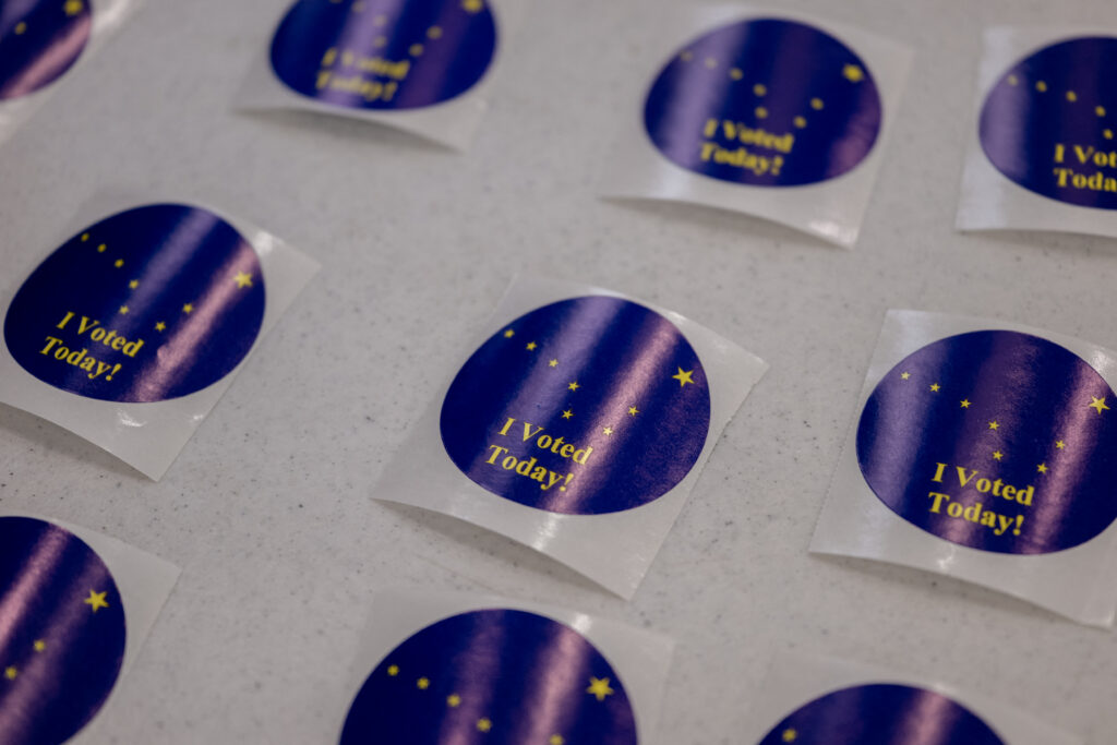 A close view shows several blue and yellow I Voted Today stickers printed with a map of Alaska at Midtown Mall in Anchorage on Oct. 29, 2026. (Photo by Christian Moorman / Hans Lucas / AFP via Getty Images)